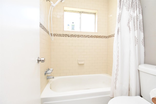 bathroom featuring toilet and shower / tub combo with curtain