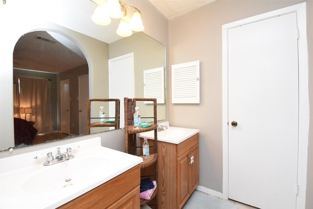 bathroom with vanity and an inviting chandelier