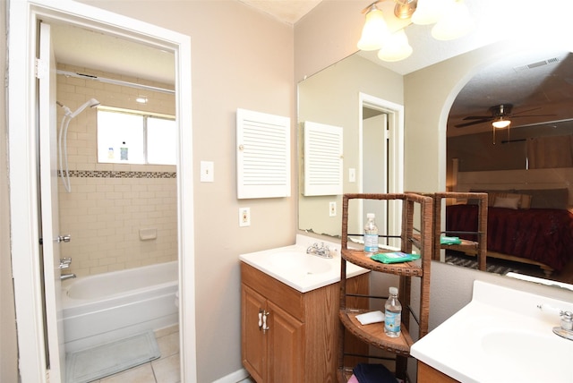 bathroom with vanity, tile patterned floors, tiled shower / bath, and ceiling fan