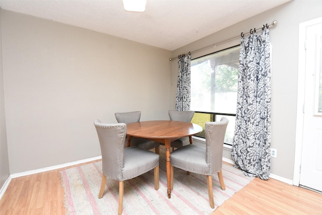 dining space with light hardwood / wood-style flooring