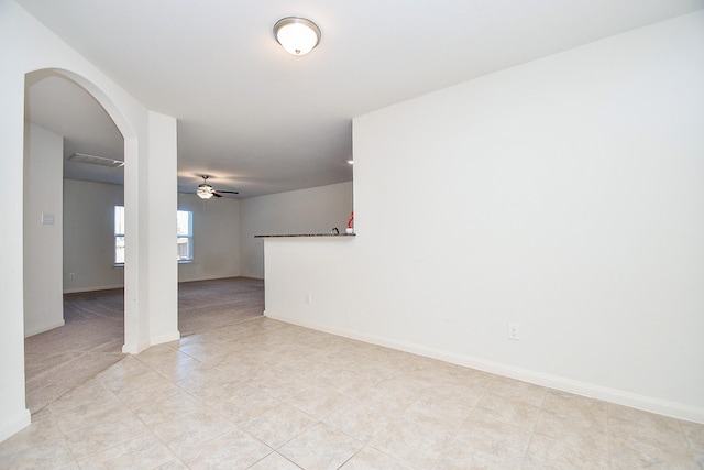 tiled spare room with ceiling fan