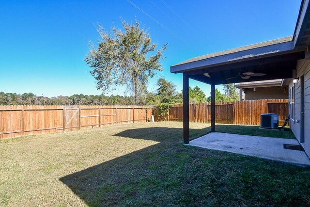 view of yard featuring ceiling fan, a patio area, and central AC