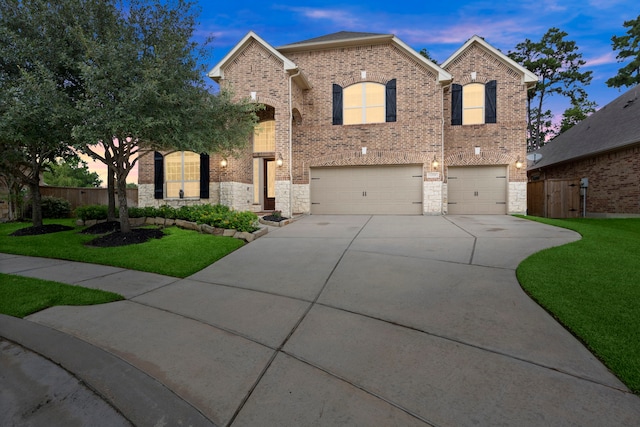 view of front of house with a yard and a garage