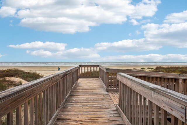 surrounding community featuring a beach view and a water view