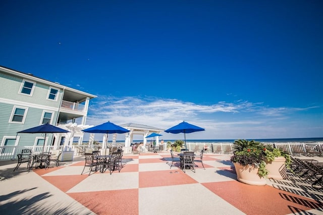 view of home's community featuring a beach view and a water view