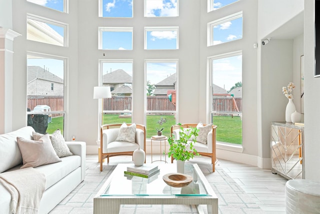 sunroom featuring ornate columns and a healthy amount of sunlight