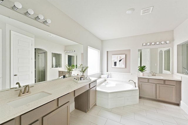 bathroom with tile patterned flooring, vanity, and separate shower and tub