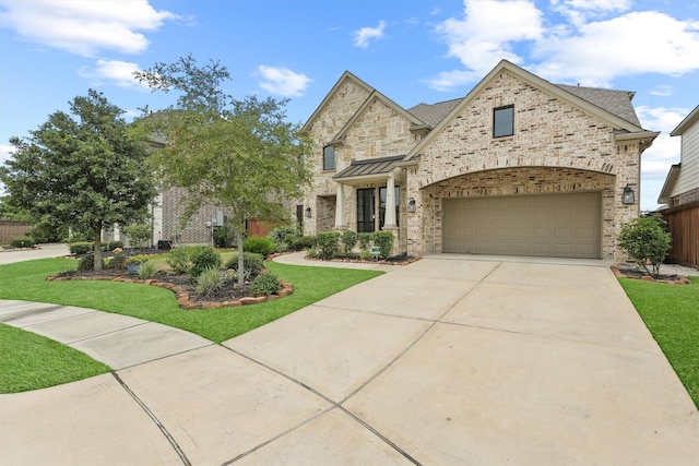 view of front of house with a front lawn and a garage