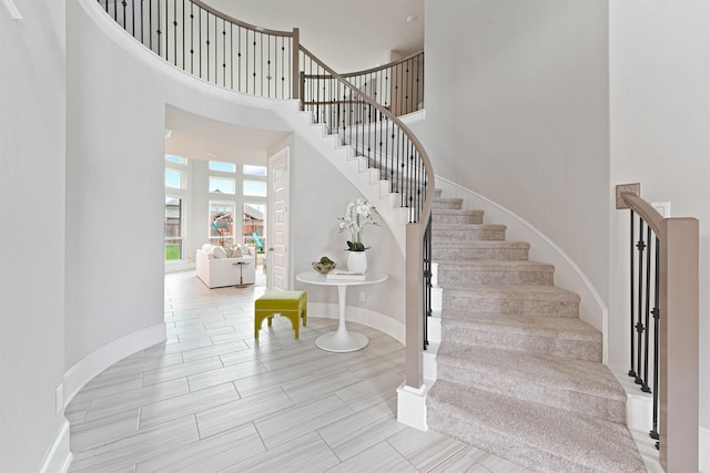 staircase featuring a towering ceiling