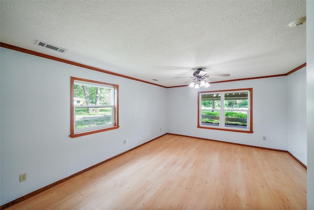 empty room with a textured ceiling, light hardwood / wood-style flooring, ceiling fan, and crown molding