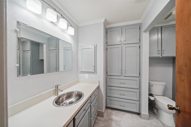 bathroom featuring tile patterned floors, toilet, vanity, and ornamental molding