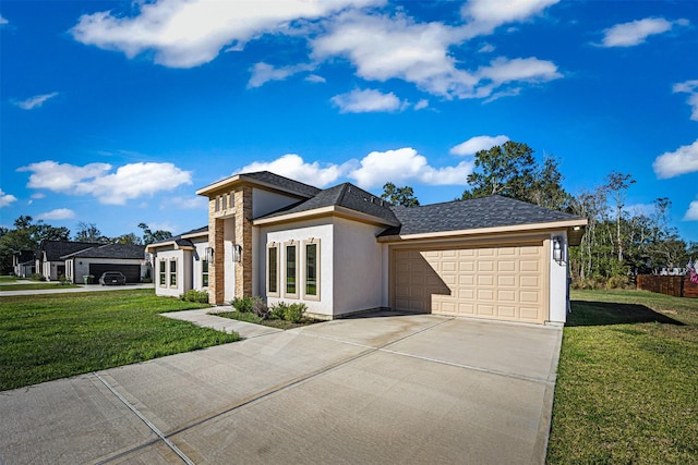 view of front of home with a garage and a front lawn