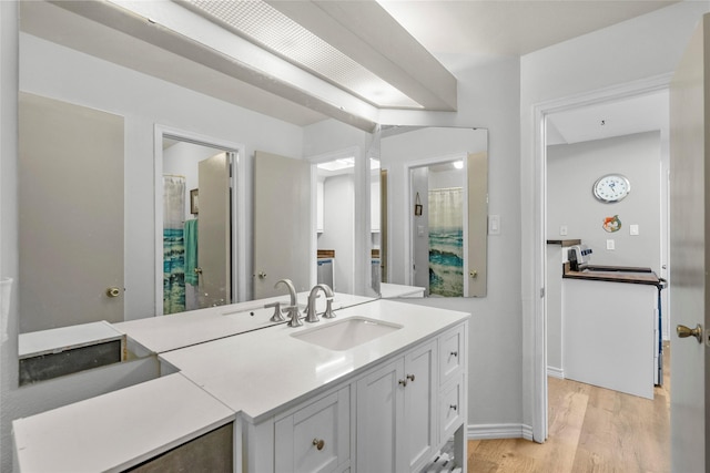 bathroom with hardwood / wood-style floors and vanity