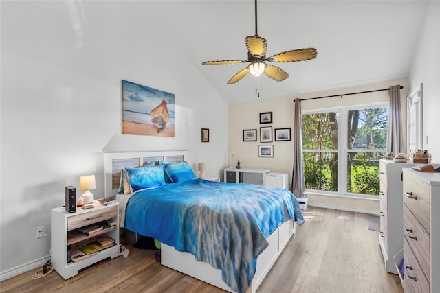 bedroom with ceiling fan, high vaulted ceiling, and light hardwood / wood-style flooring