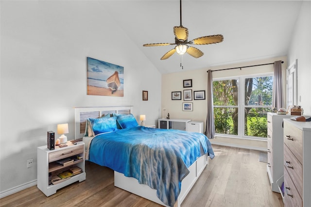 bedroom with light wood-type flooring, high vaulted ceiling, and ceiling fan