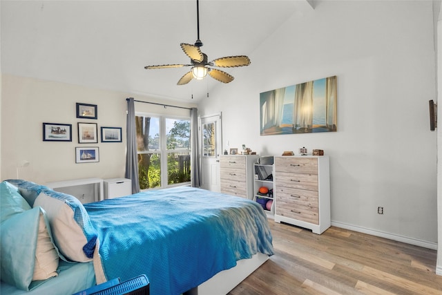 bedroom featuring ceiling fan, light hardwood / wood-style floors, and high vaulted ceiling