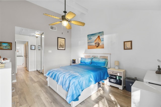 bedroom featuring beam ceiling, light wood-type flooring, high vaulted ceiling, and ceiling fan