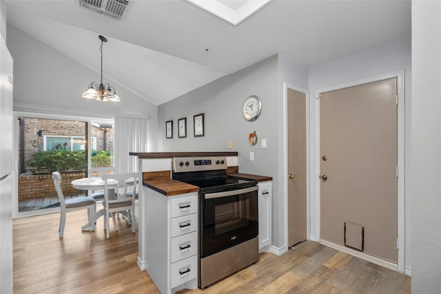 kitchen with white cabinets, light wood-type flooring, lofted ceiling, and electric stove