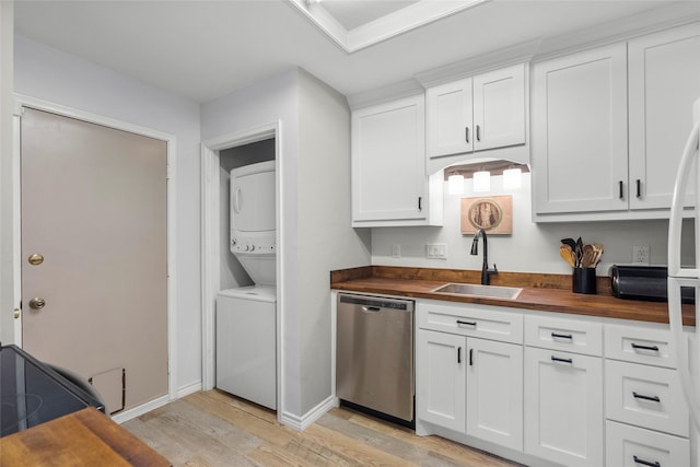 kitchen with wooden counters, sink, stacked washer and clothes dryer, dishwasher, and light hardwood / wood-style floors