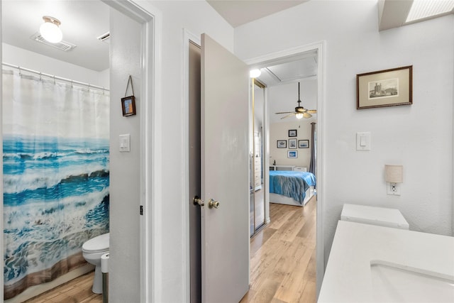 bathroom featuring vanity, curtained shower, toilet, and wood-type flooring