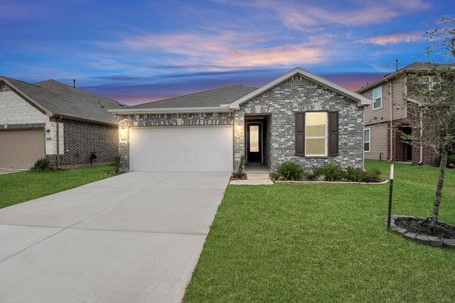 view of front of home featuring a garage and a lawn