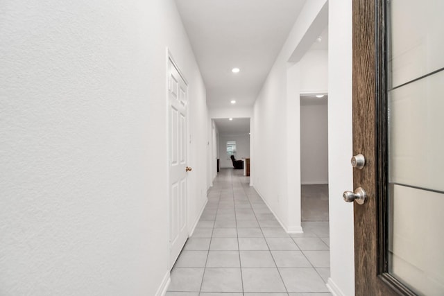 hall with light tile patterned floors