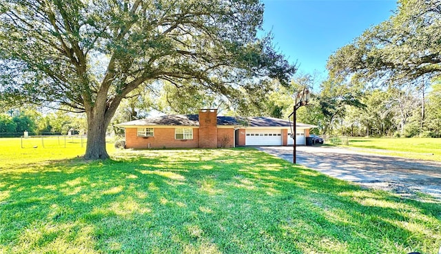 single story home with a garage and a front lawn