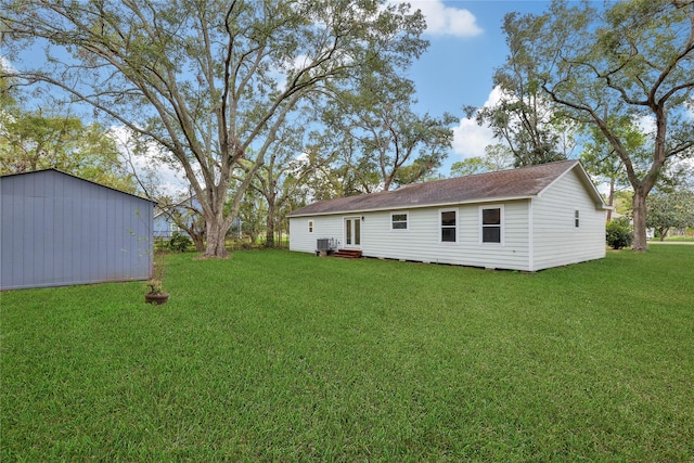 rear view of property featuring a lawn