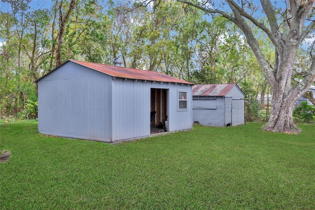 view of outdoor structure featuring a lawn