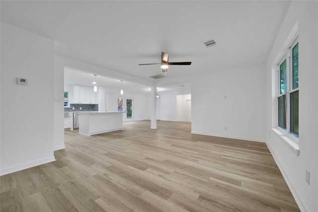 unfurnished living room featuring light hardwood / wood-style flooring and ceiling fan