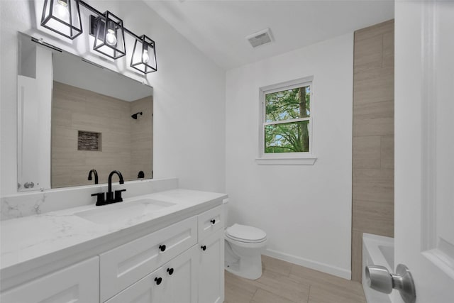 full bathroom with vanity, toilet, and tiled shower / bath