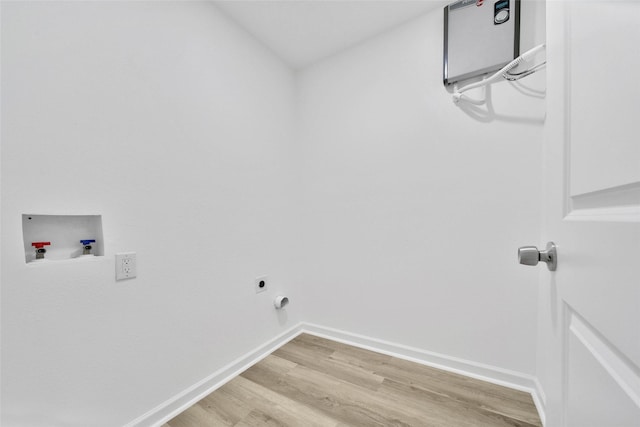 clothes washing area featuring hardwood / wood-style flooring, electric dryer hookup, and washer hookup