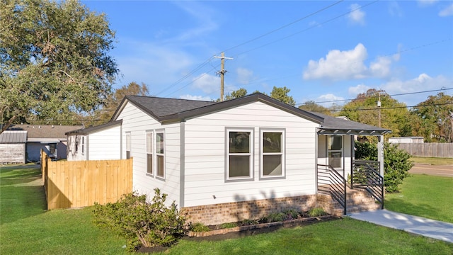 view of side of property with a lawn