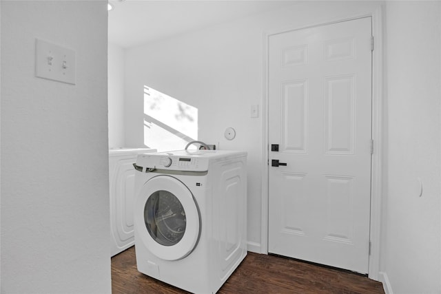 laundry room featuring dark hardwood / wood-style flooring and washer / dryer