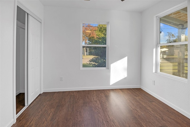 unfurnished bedroom with a closet and dark wood-type flooring