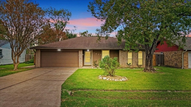 ranch-style home featuring a yard and a garage