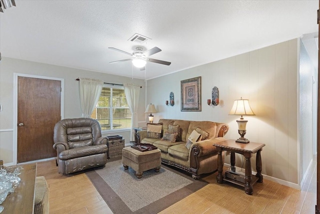 living room with light wood-type flooring and ceiling fan