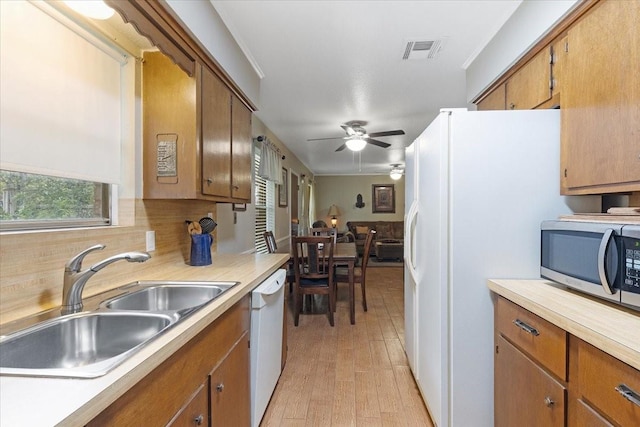 kitchen featuring ceiling fan, sink, backsplash, light hardwood / wood-style floors, and white appliances