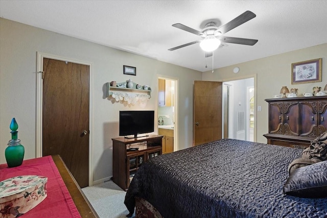 bedroom with light wood-type flooring, ensuite bathroom, and ceiling fan