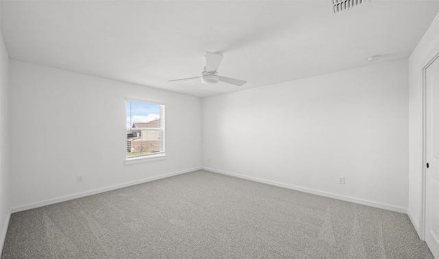 carpeted spare room with ceiling fan