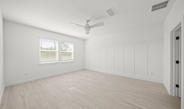 spare room with light wood-type flooring and ceiling fan