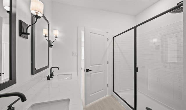 bathroom with an enclosed shower and sink