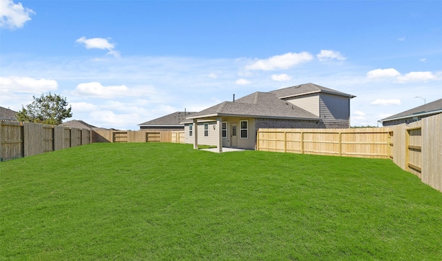 rear view of house featuring a lawn