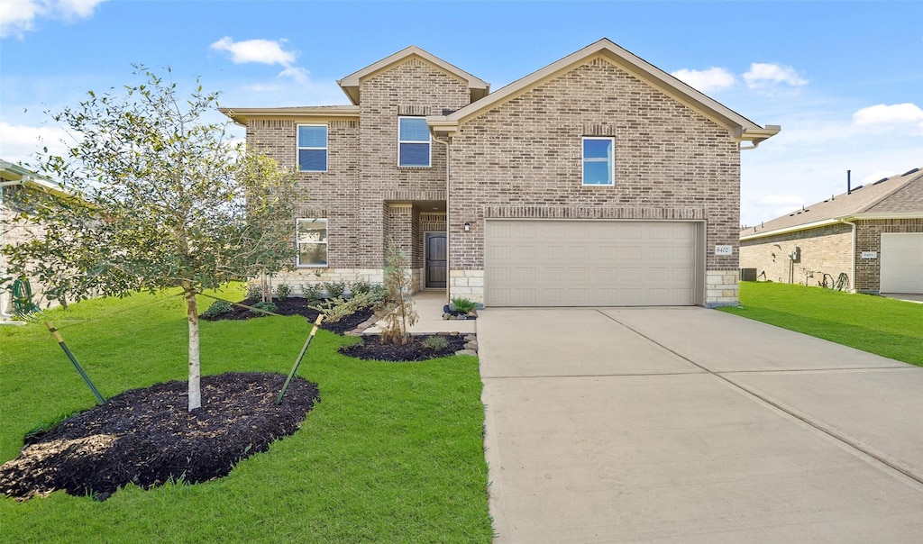 front facade with a garage and a front lawn