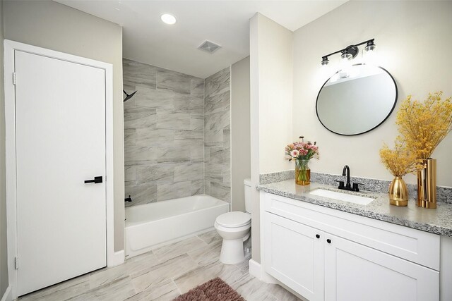 full bathroom featuring vanity, toilet, and tiled shower / bath combo