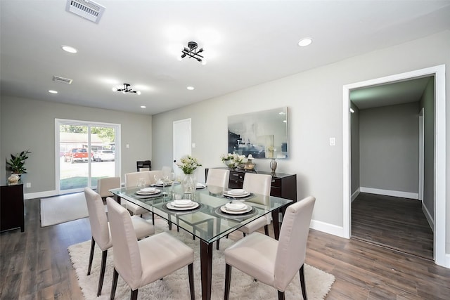 dining space with dark hardwood / wood-style floors