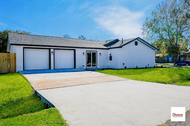 single story home featuring a front lawn and a garage