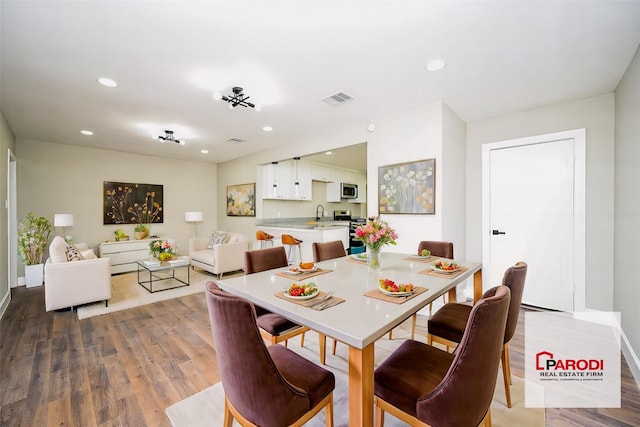 dining space with hardwood / wood-style flooring