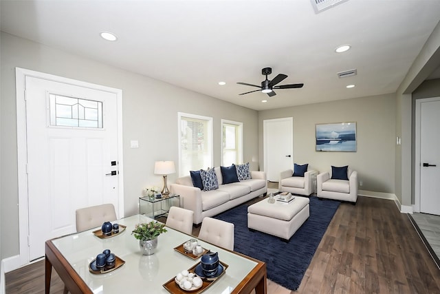 living room with dark wood-type flooring and ceiling fan