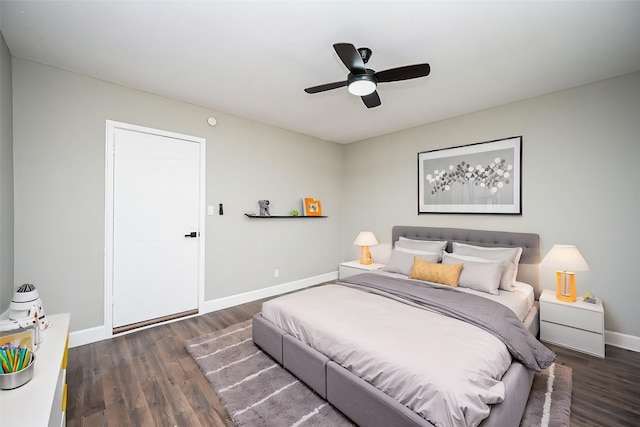 bedroom with dark hardwood / wood-style flooring and ceiling fan